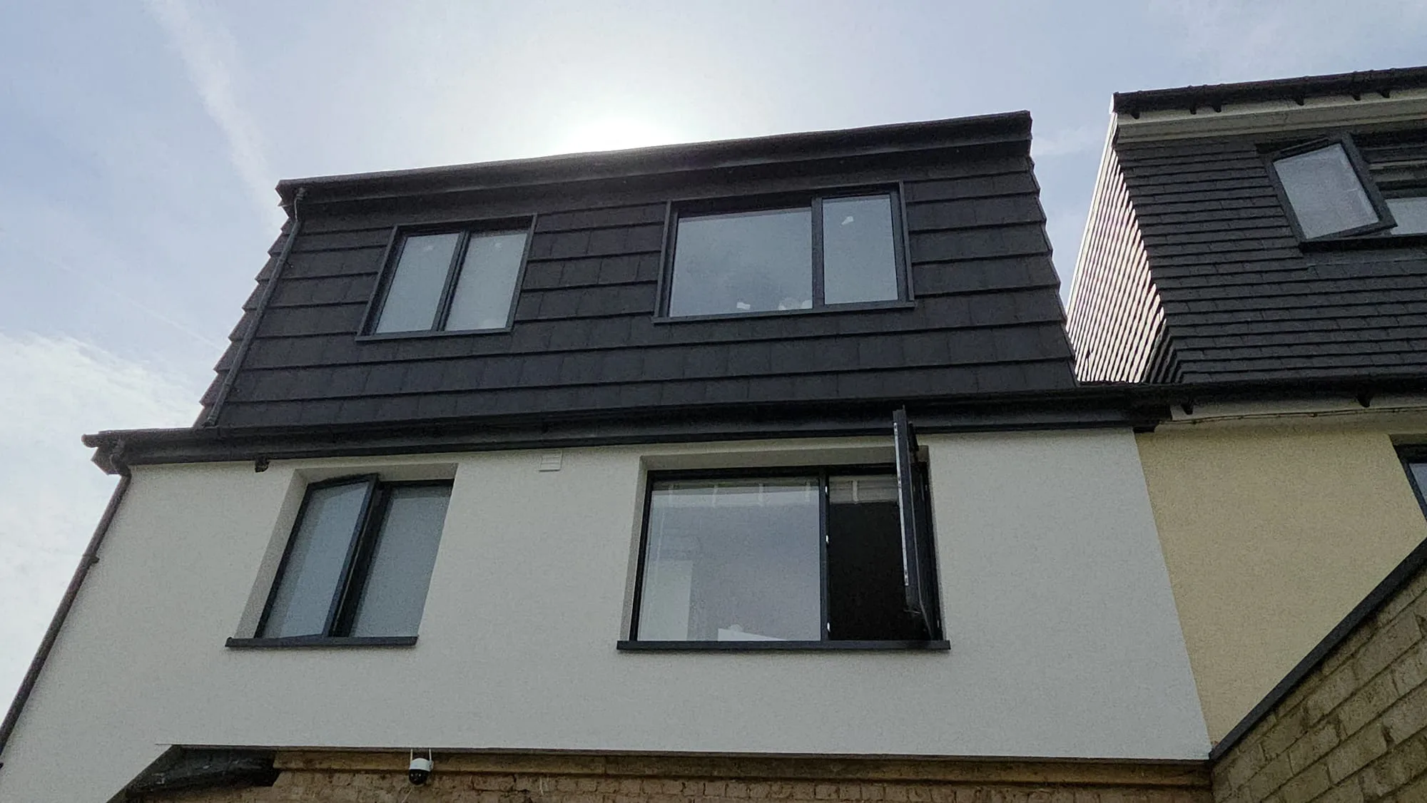 Roof installation with sloped design and large windows for natural light