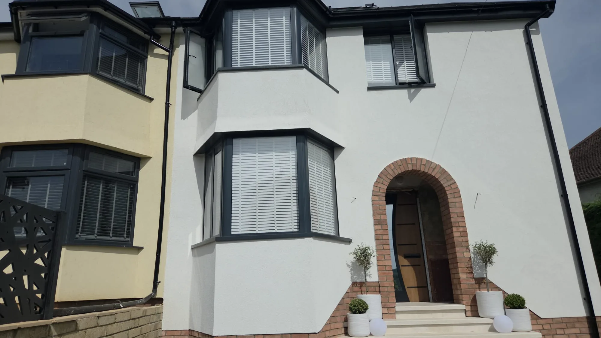 Modern home facade with large windows and an inviting entrance