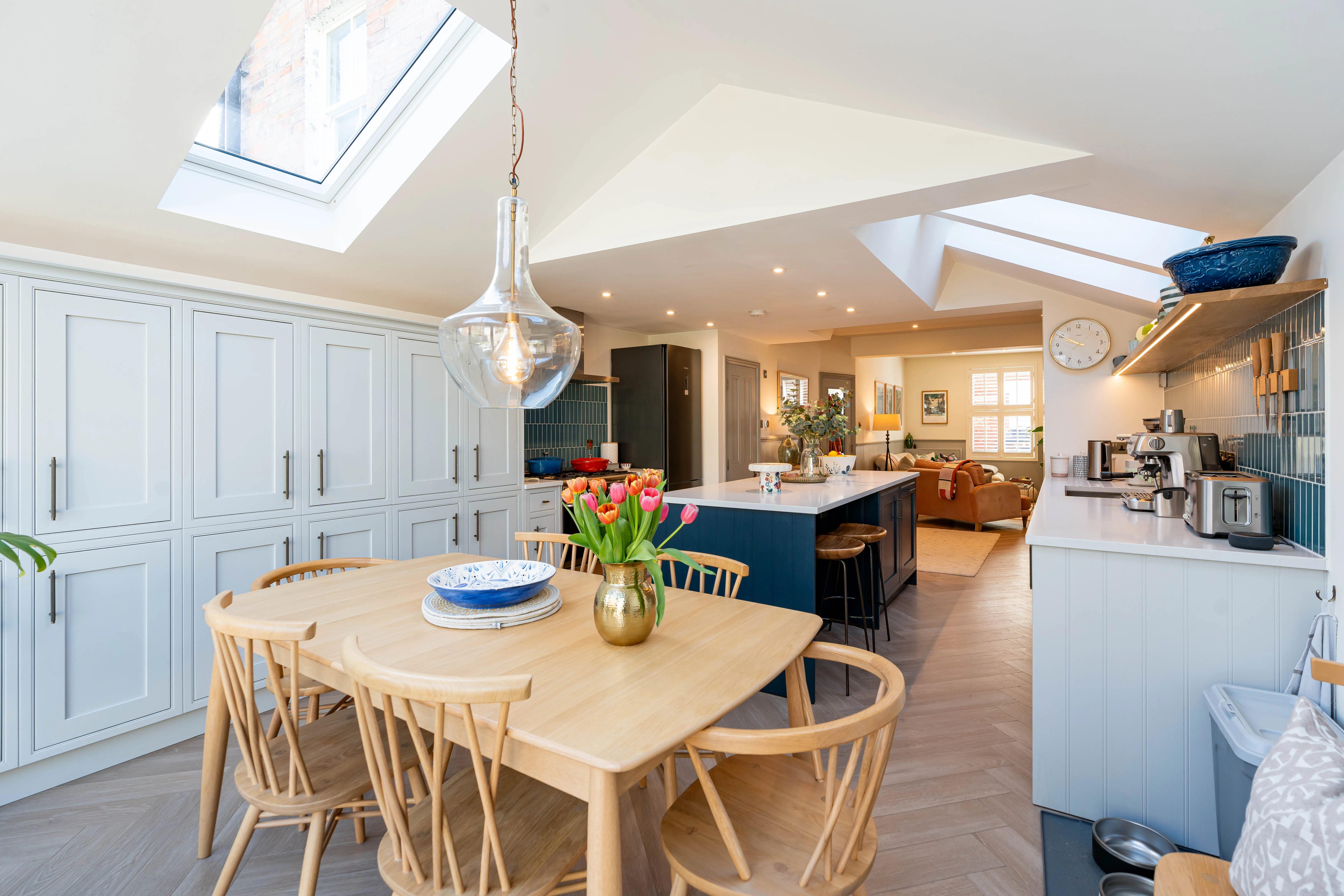 Modern kitchen refurbishment featuring a wooden dining table and bright skylight