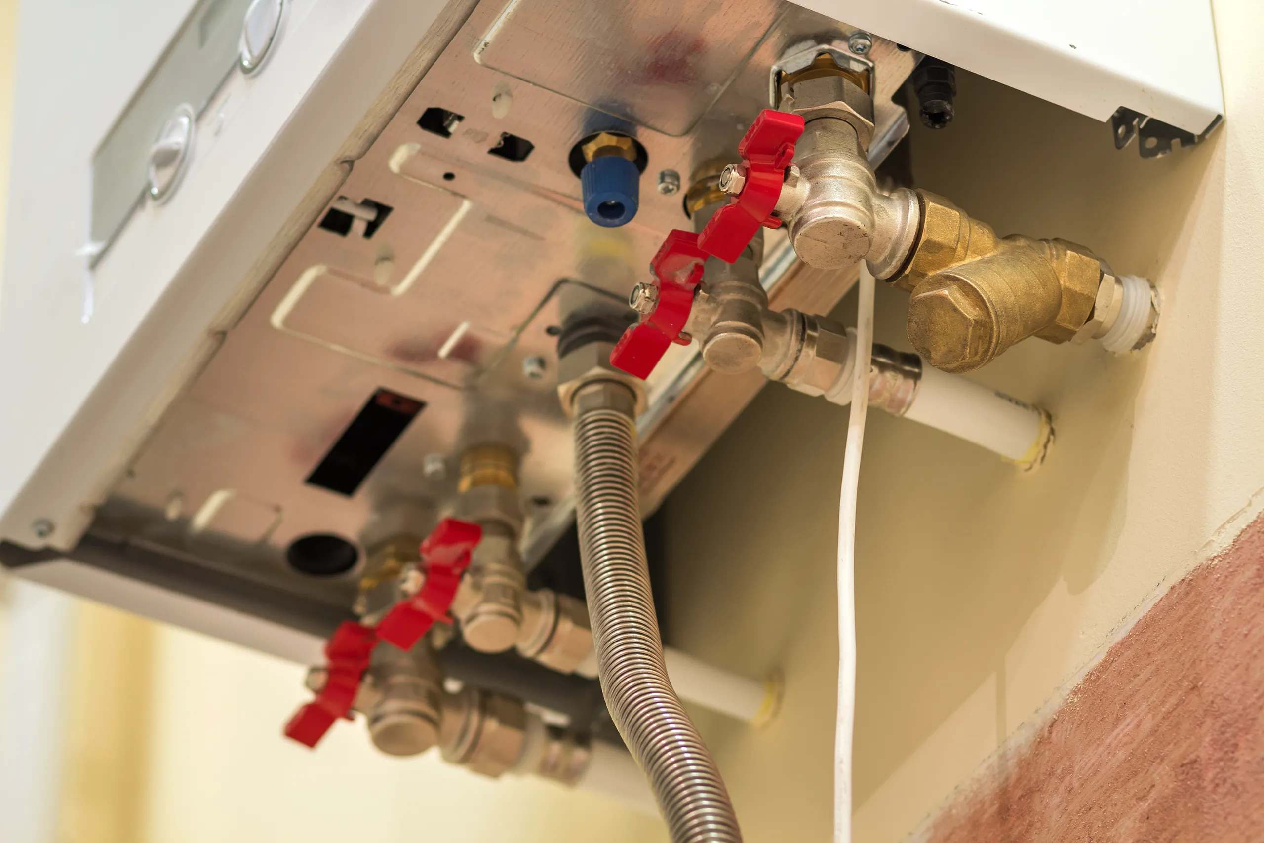 Close-up of a gas boiler installation showcasing pipes and valves