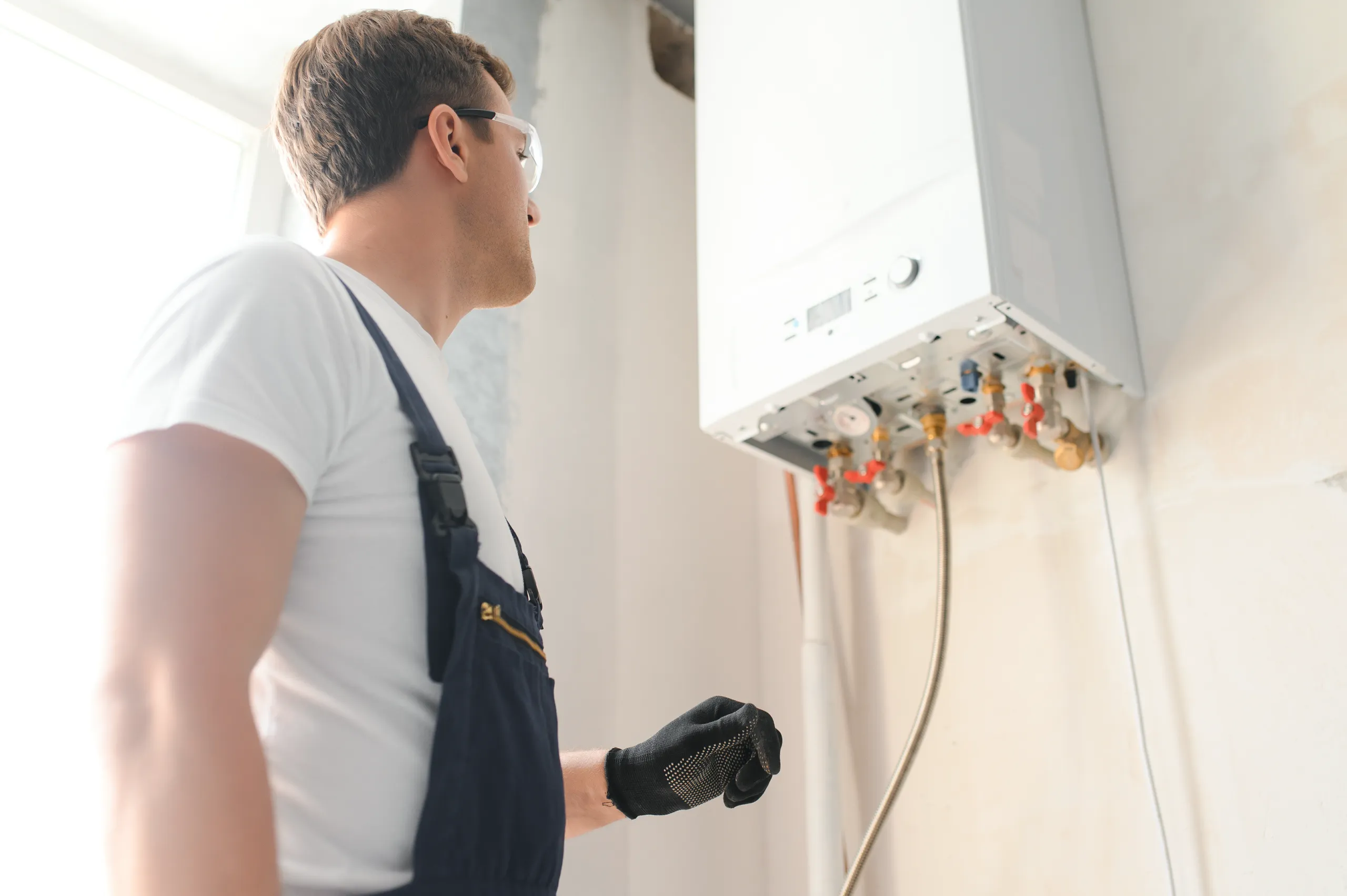 Technician installing a gas boiler in a home refurbishment project