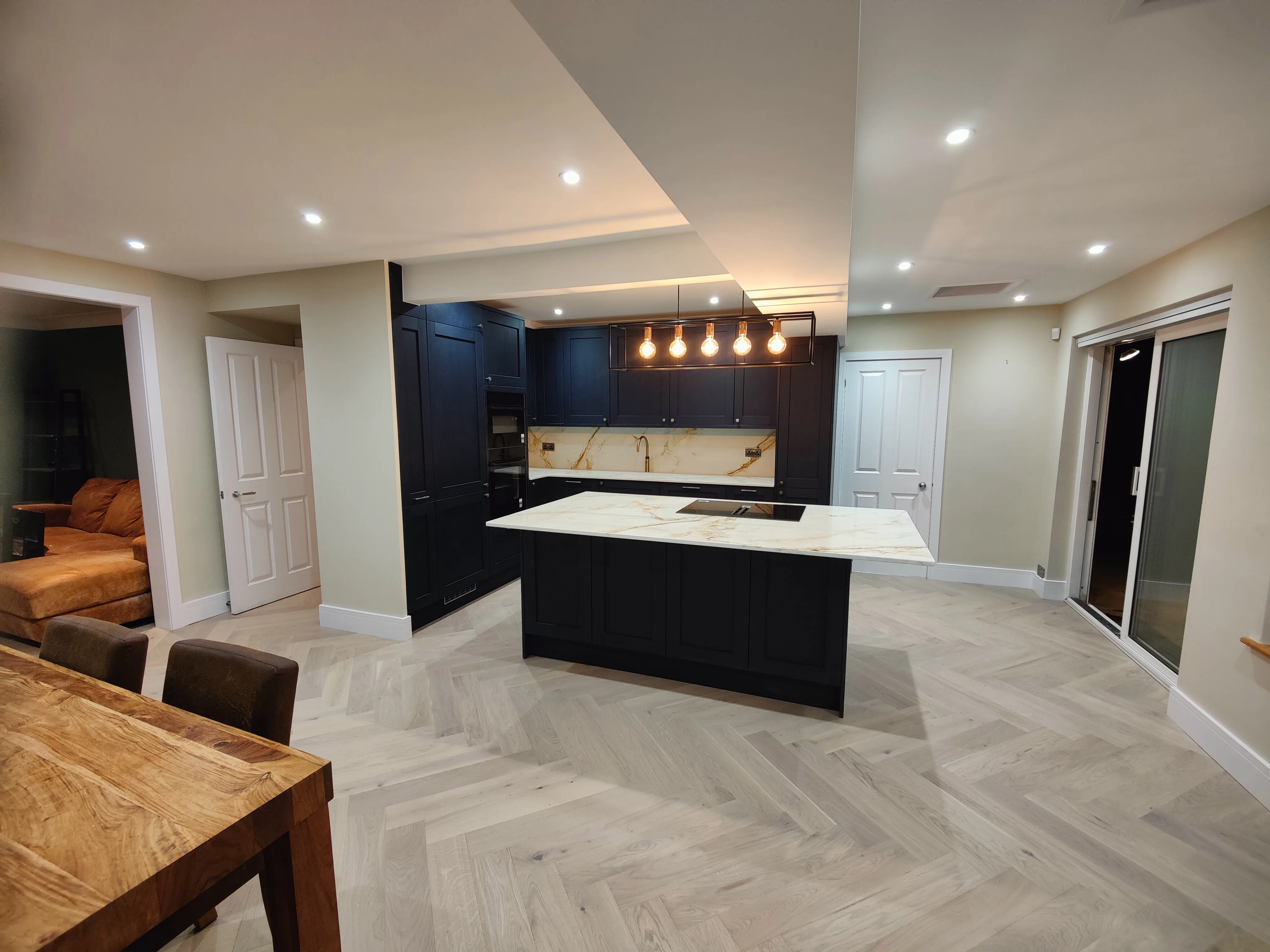 Modern kitchen refurbishment featuring a stylish island and wooden flooring
