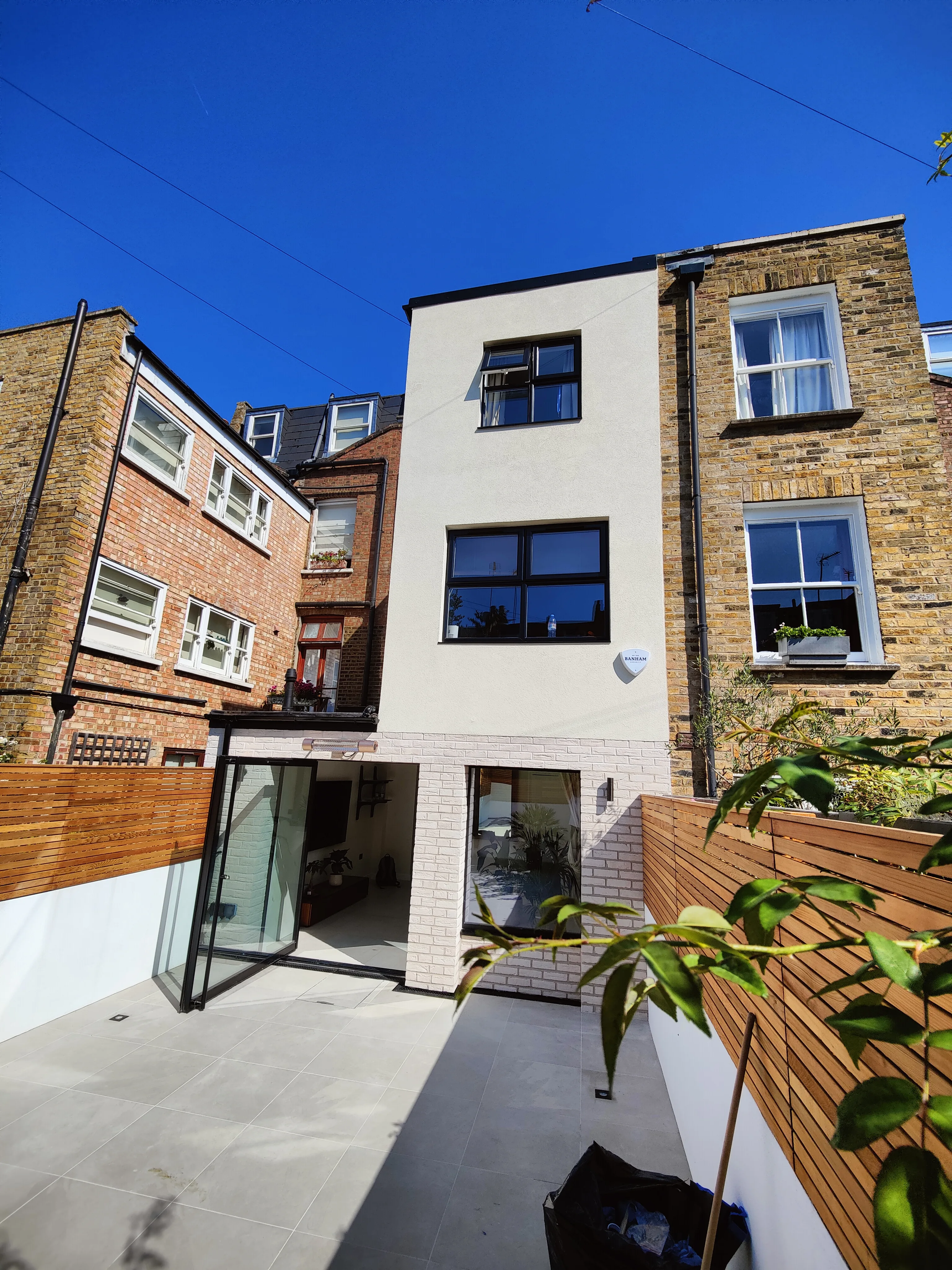 Modern house extension with large glass doors and a light-filled courtyard