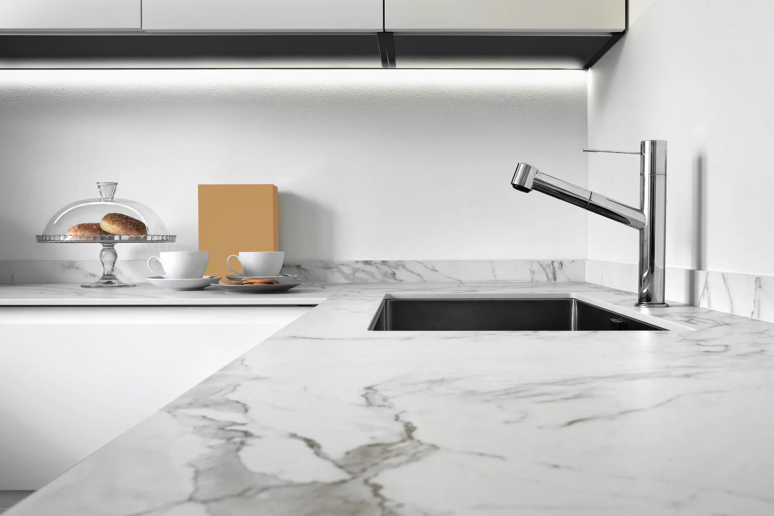 Modern kitchen with marble countertop, sink, and elegant accessories