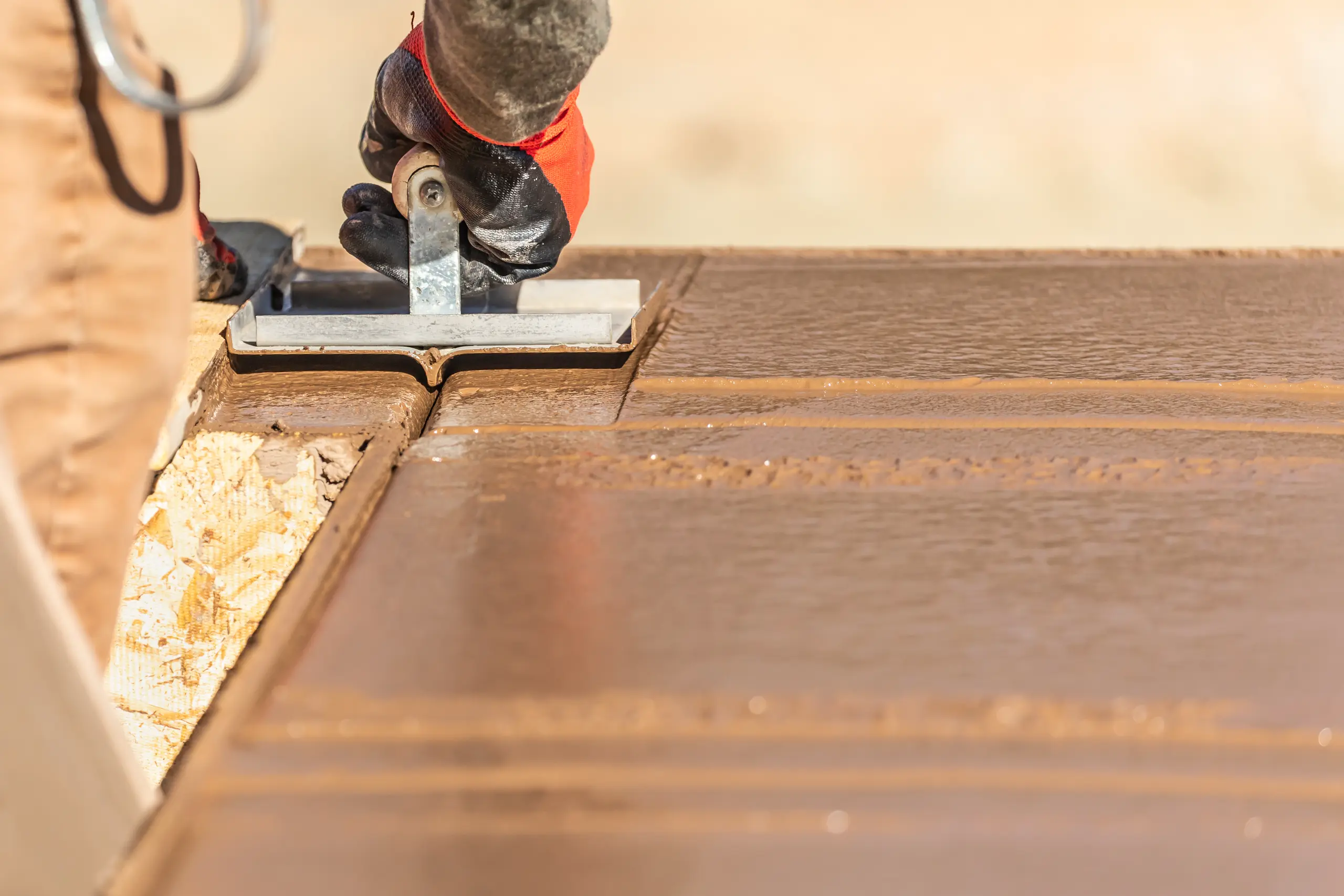 Worker applying finishing touches to a smooth surface during home refurbishment
